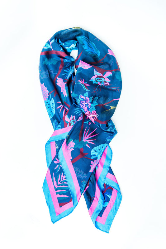 Brilliant blue, pink and wine silk scarf folded into the shape of a ribbon